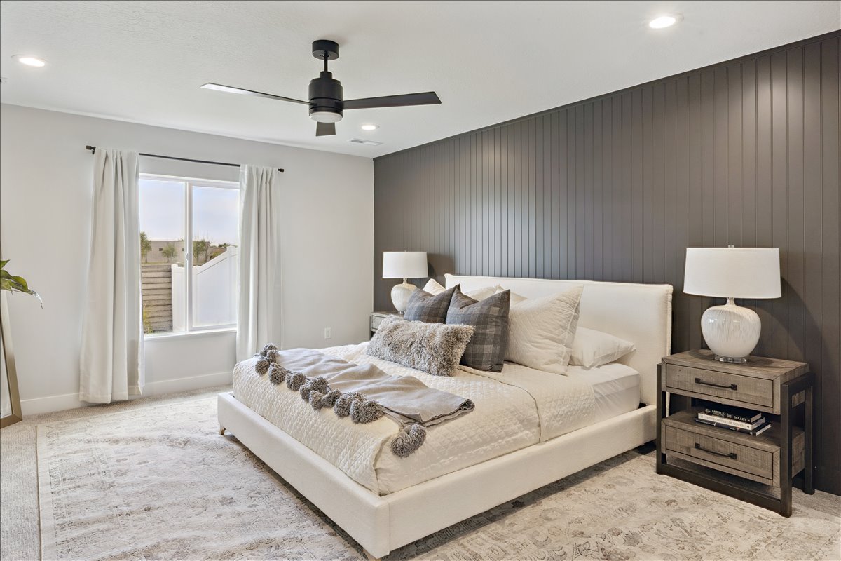 Carpeted bedroom featuring an accent wall, ceiling fan, and recessed lighting