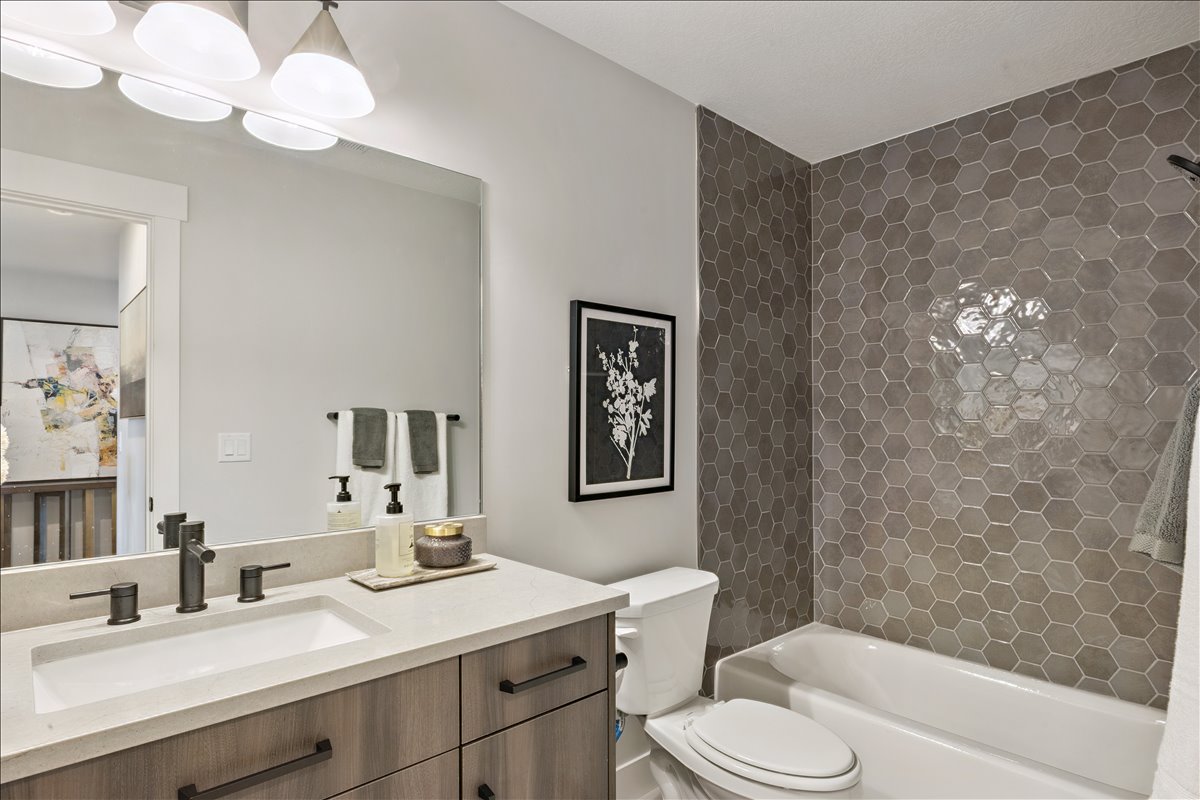 Bathroom with vanity and tub / shower combination