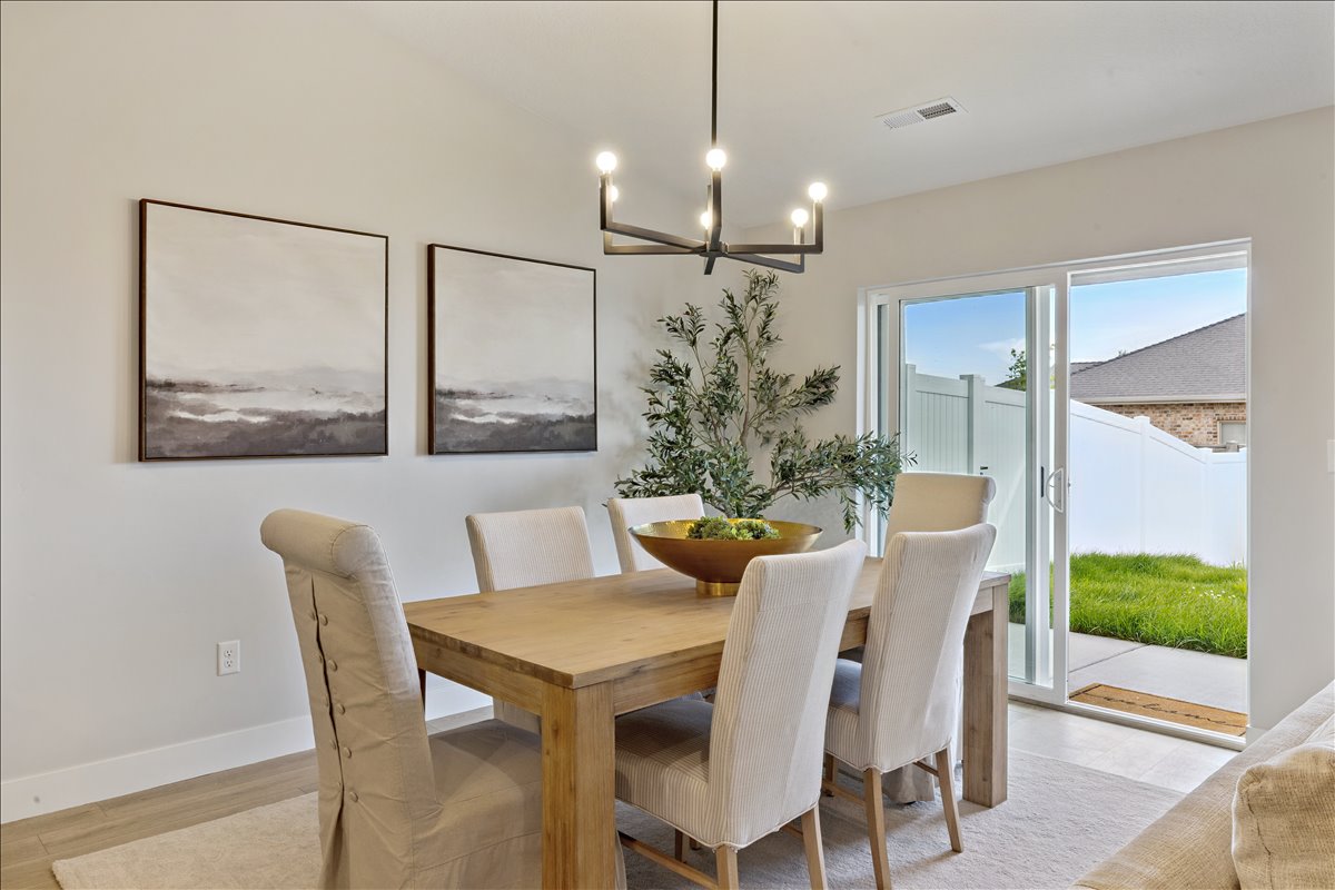 Dining space with a chandelier and light wood-style flooring