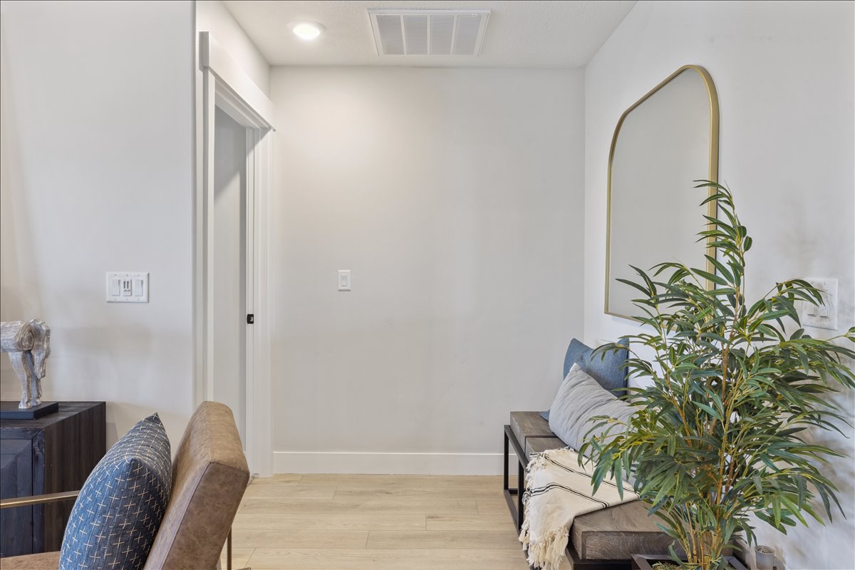 Corridor with light wood-style floors and recessed lighting