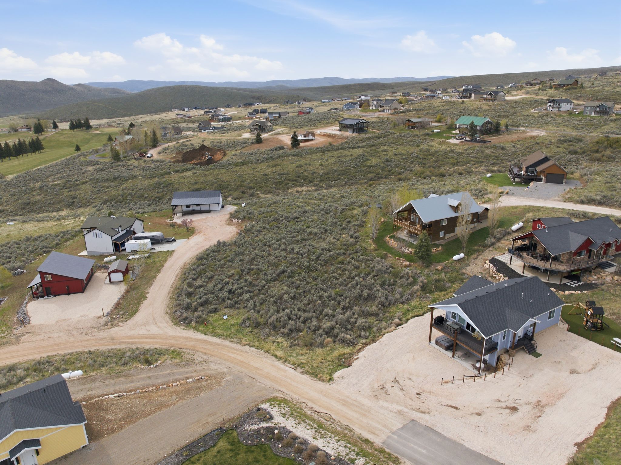 Aerial view of property's location featuring nearby suburban area and a mountain backdrop