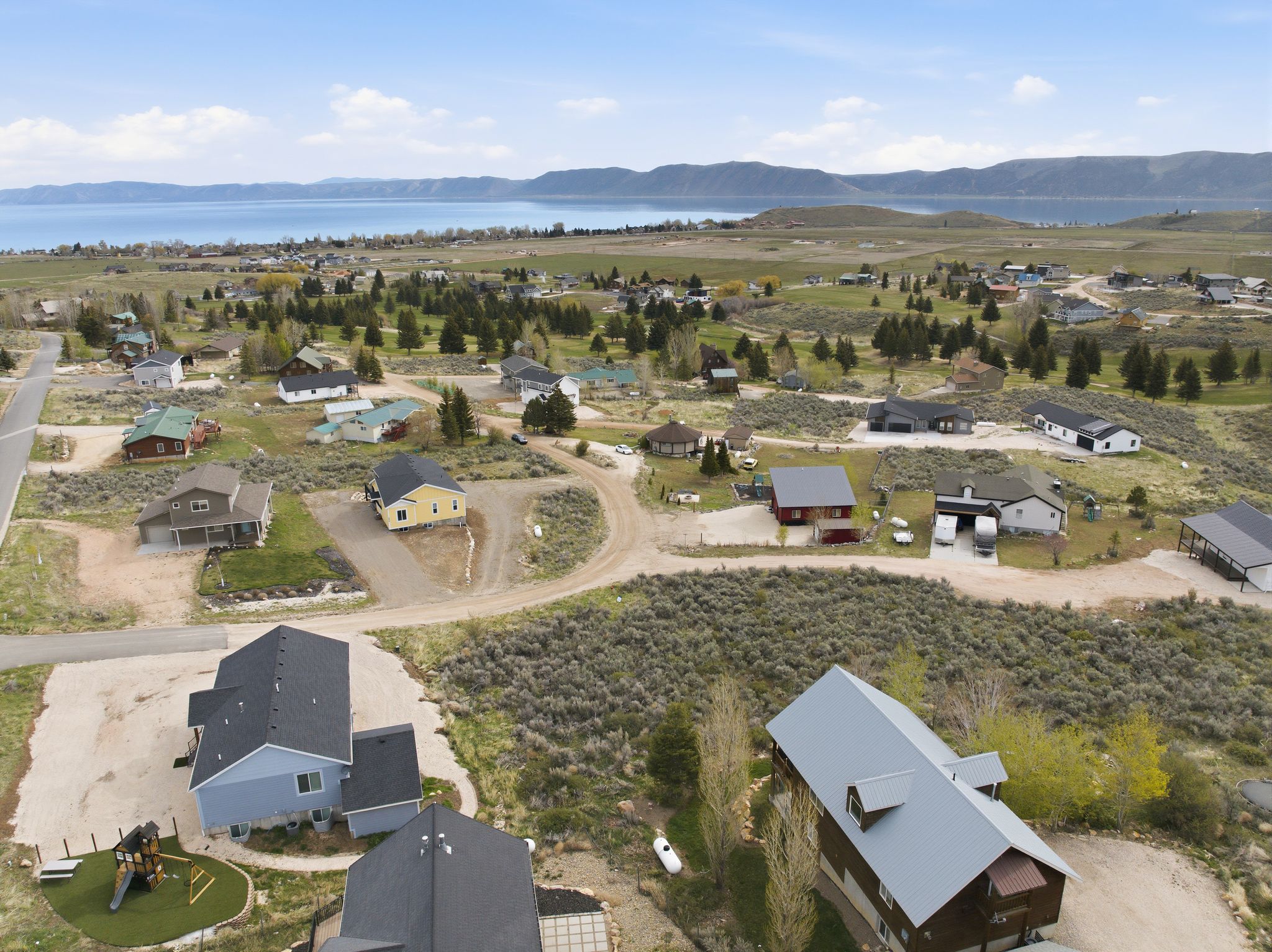 Aerial view of property's location featuring nearby suburban area and a mountainous background