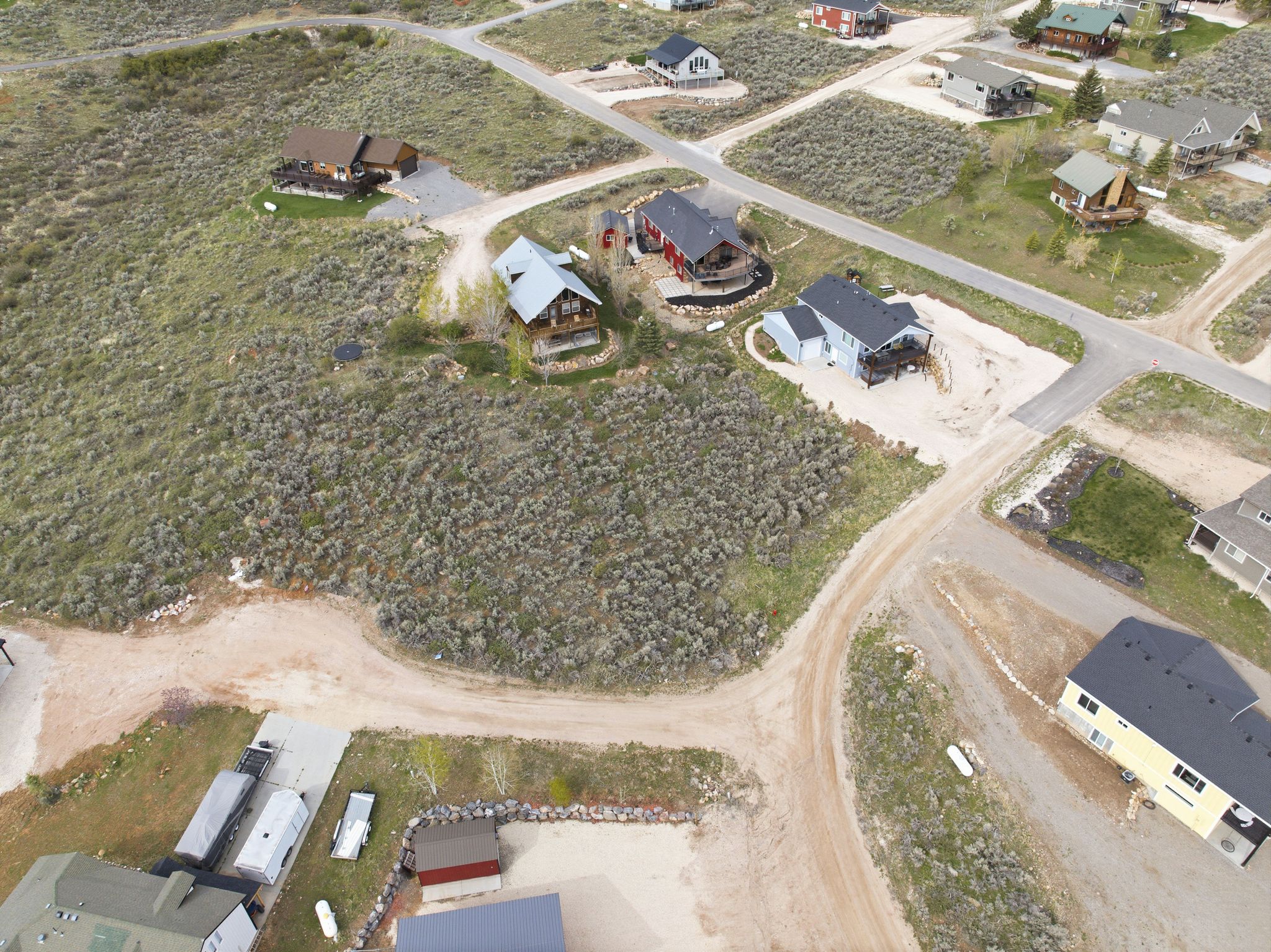 Aerial view of property and surrounding area featuring nearby suburban area
