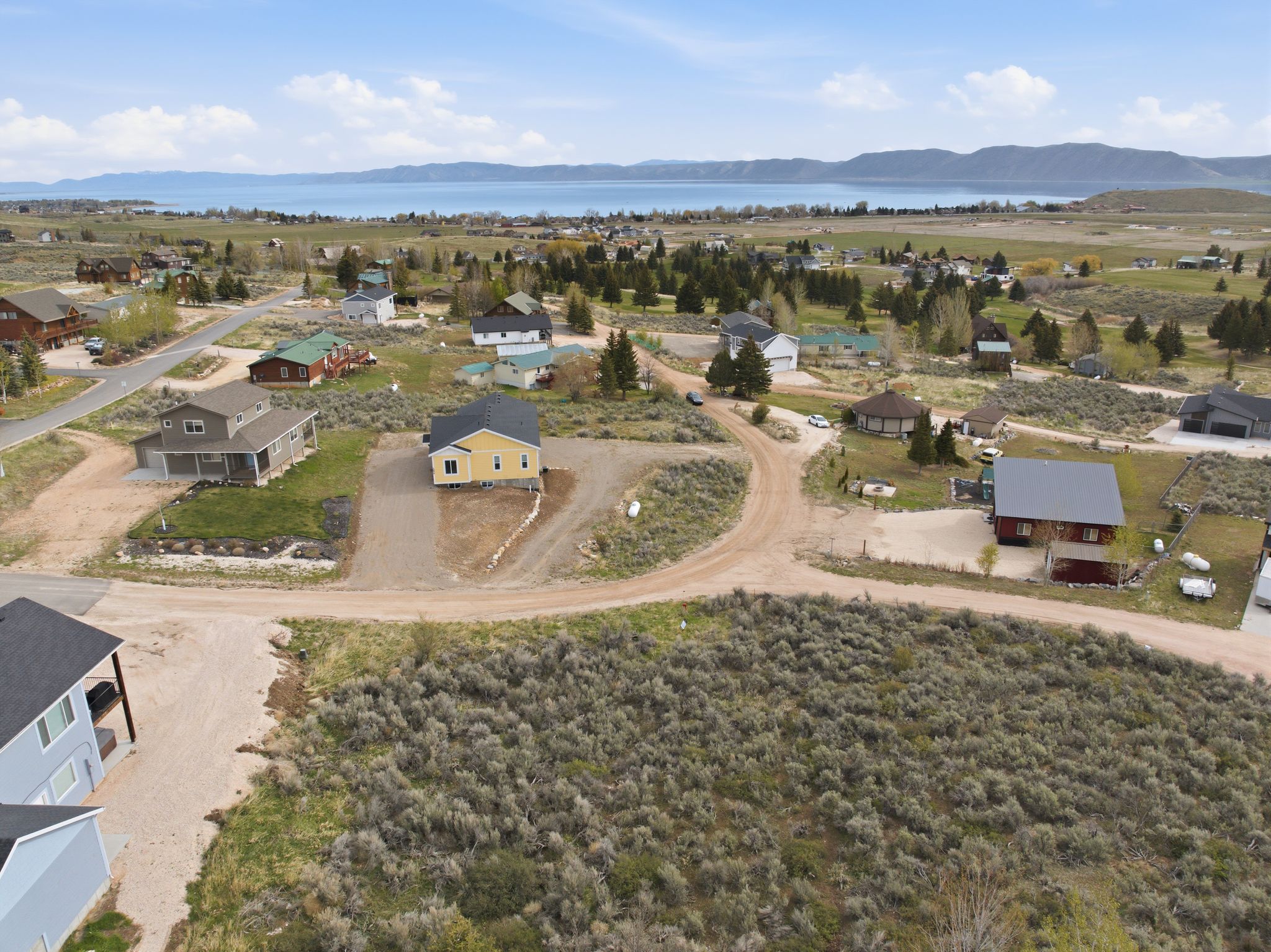 Aerial view of property's location with a mountainous background and nearby suburban area