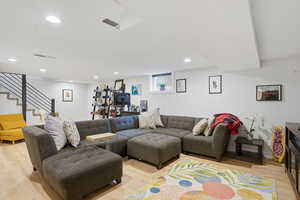 Living area featuring light wood-style floors and recessed lighting