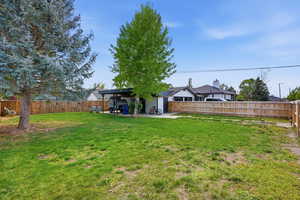 Fenced backyard with a patio area