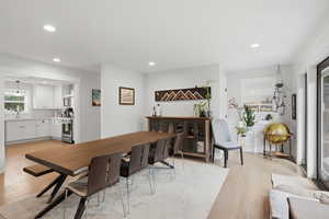 Dining space featuring light wood-style flooring and recessed lighting