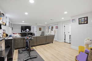 Exercise room featuring light wood-type flooring and recessed lighting