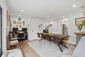 Dining room with a desk, light wood-type flooring, and recessed lighting
