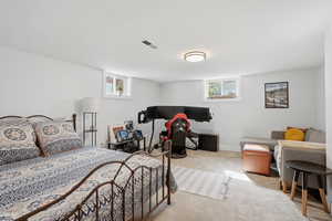 Bedroom featuring light colored carpet and baseboards