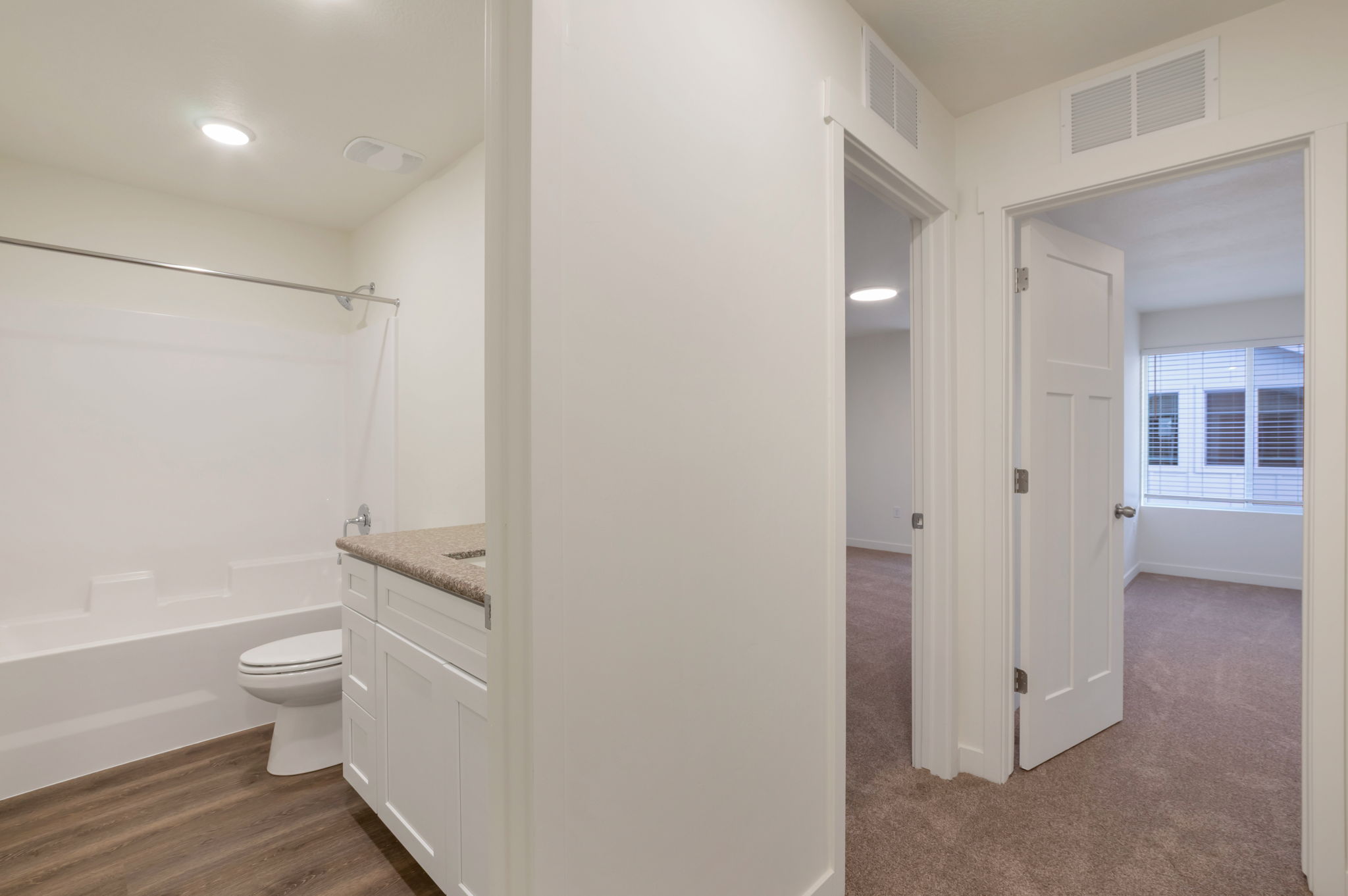 Full bath with vanity, shower / tub combination, and dark wood-style floors