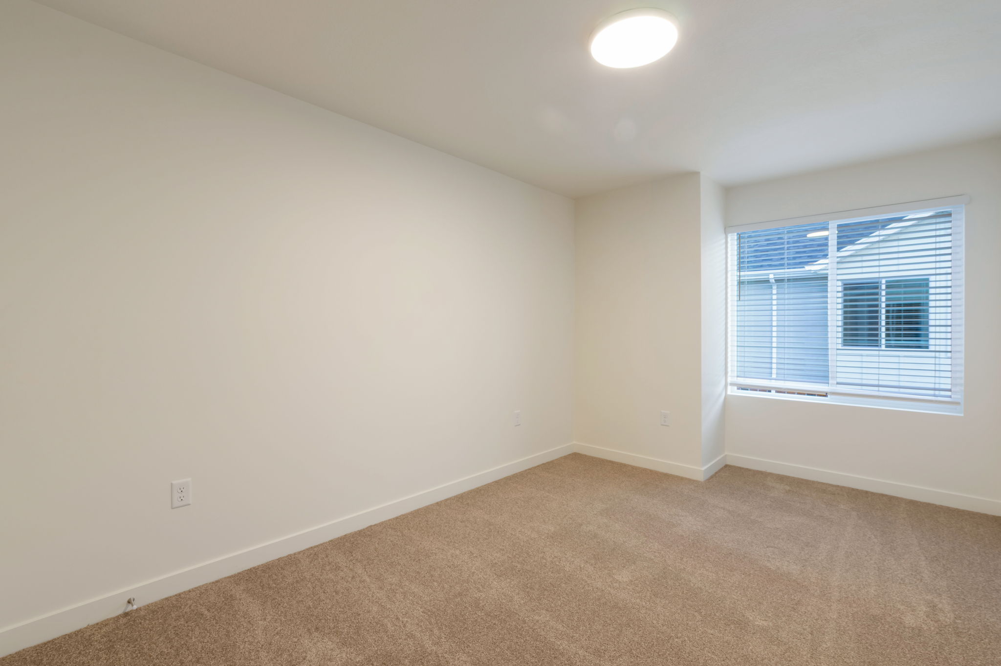 Empty room featuring baseboards and carpet floors