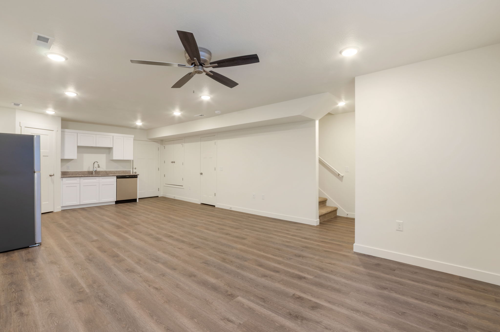 Unfurnished living room featuring ceiling fan, light wood finished floors, and recessed lighting
