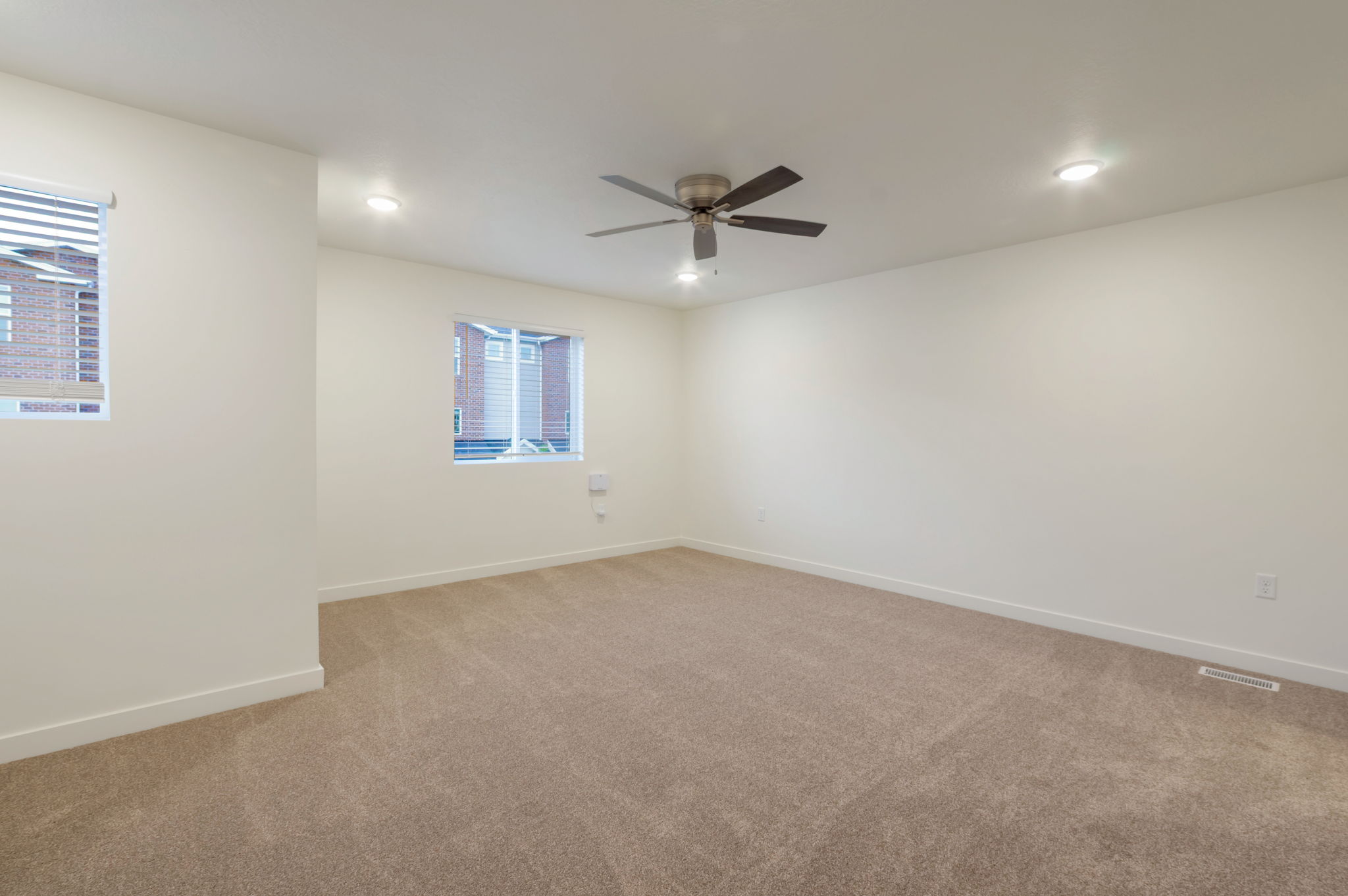 Spare room featuring light carpet, recessed lighting, and a ceiling fan