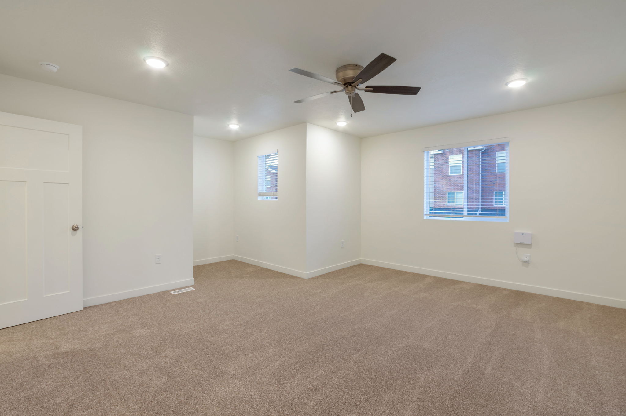 Spare room with carpet floors, a ceiling fan, and recessed lighting