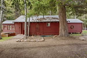 View of front of home featuring a metal roof and faux log siding
