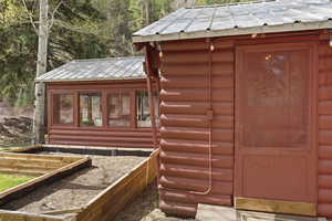 View of outbuilding with a garden