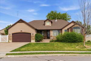 View of front of house featuring a garage, stone siding, roof with shingles, stucco siding, and concrete driveway