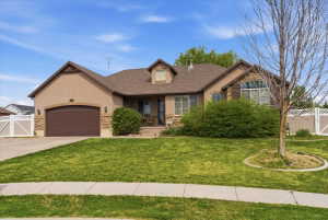 View of front of property featuring a gate, a garage, stucco siding, concrete driveway, and a porch