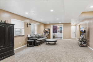 Living area featuring light carpet and recessed lighting