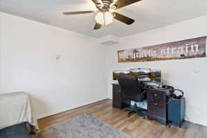 Office space featuring light wood finished floors and a ceiling fan