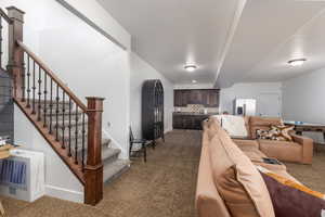 Living area featuring dark carpet and heating unit