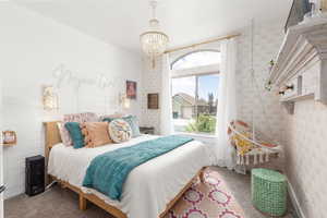 Bedroom featuring carpet flooring and hanging lights