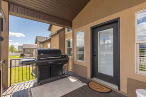 Entrance to property with a wooden deck and a yard