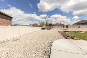 Fenced backyard featuring a residential view