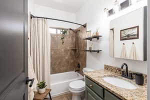 Bathroom with vanity and shower / tub combo