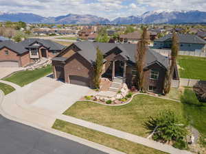 View of front of property featuring driveway, a front lawn, a residential view, and an attached garage