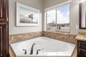Bathroom with vanity and a jetted tub