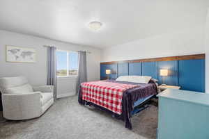 Bedroom featuring carpet flooring and baseboards