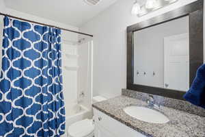 Bathroom featuring vanity and shower / bath combo