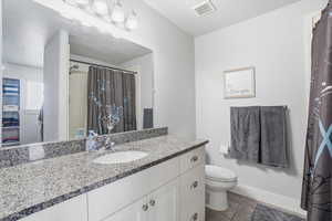 Bathroom with vanity and curtained shower