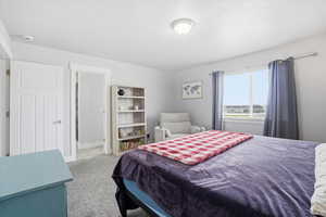 Bedroom with light carpet and baseboards