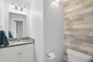 Half bath featuring vanity and toilet