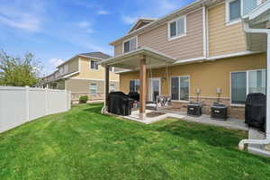 Back of property featuring a patio area and stone siding