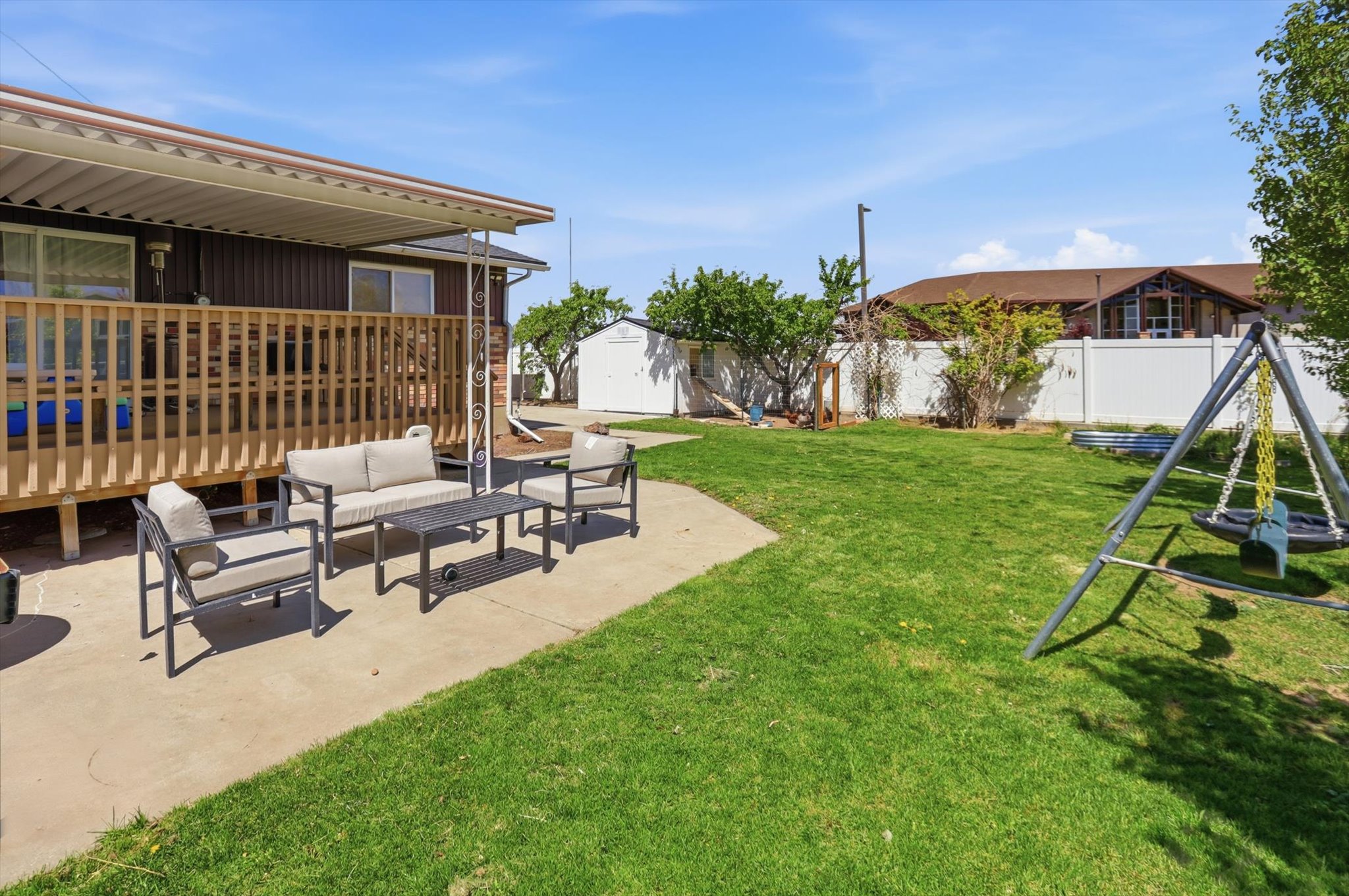 Fenced backyard featuring a patio area, outdoor lounge area, and a shed