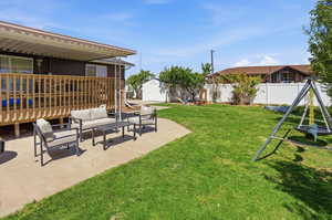 Fenced backyard featuring a patio area, outdoor lounge area, and a shed
