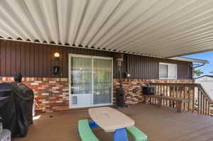 Porch featuring grilling area and a storage shed