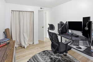 Office area with light wood-style floors