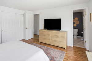 Bedroom featuring light wood finished floors and a closet