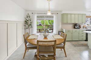 Dining room with a decorative wall and a wainscoted wall