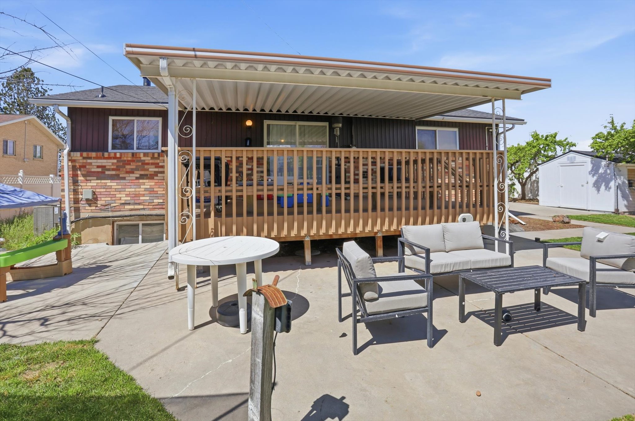 View of patio / terrace with outdoor seating and a shed