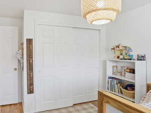 Bedroom featuring a closet and light wood-type flooring
