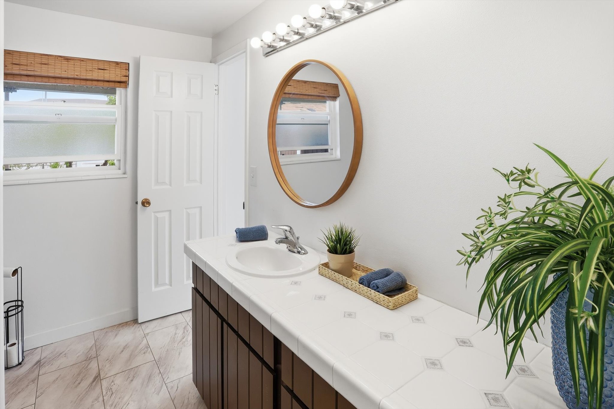 Bathroom with vanity and light marble finish floors