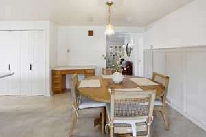 Dining area with a decorative wall and concrete flooring