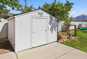 View of shed featuring a fenced backyard and a mountain view