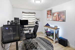Office with light wood-style floors and baseboards